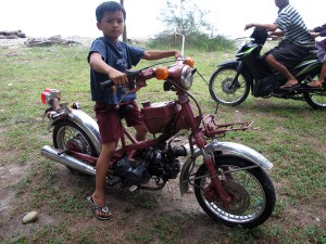 They start driving pretty young in Sumatra. They also peer backwards after they have passed you to stare at the sight.... I've also seen a man who would be classified as legally blind driving a moped the wrong way down a highway. Road safety at it's best (photo by Monika)