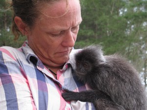 Cuddling the Top Knot Twin's pet monkey, wondering how many fleas/lice were traversing the small space between us. (Photo by Monika)