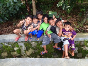 Some Indonesian kids watching as we try to hitch a lift in Sumatra