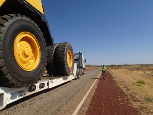 Dwarfed by a dumptruck being transported along the Stuart Highway, Mum holds her breath and hopes for the best.